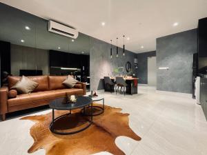 a living room with a couch and a table at Designer Suite Quill Residence by Hausome in Kuala Lumpur
