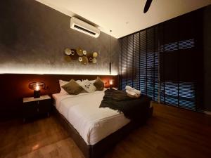 a bedroom with a large bed and a large window at Designer Suite Quill Residence by Hausome in Kuala Lumpur