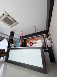 a food counter in a restaurant with a white sign at G Star Hotel in Pantai Remis