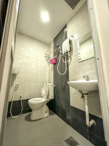 a bathroom with a toilet and a sink at G Star Hotel in Pantai Remis +10 photos