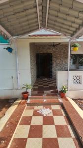 a lobby of a building with a checkered floor at Sri Krishna Cottage in Yelagiri