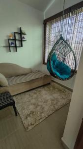 a room with a hammock and a swing at Sri Krishna Cottage in Yelagiri