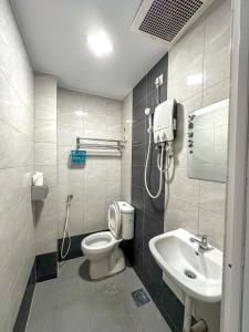 a bathroom with a toilet and a sink at G Star Hotel in Pantai Remis