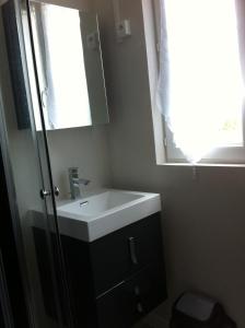 a bathroom with a sink and a mirror at Melitine in Saint-Amand-Montrond