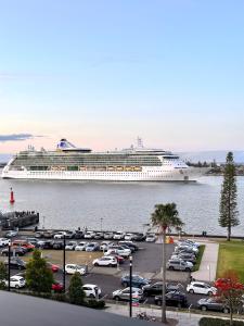 a cruise ship is docked in a parking lot at Balmoral on Scott - Harbour Front Perfection in Newcastle