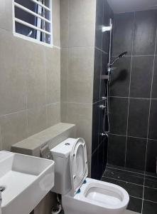 a bathroom with a toilet and a sink and a shower at Apartment in Sandakan @ Sri Indah Condominium in Sandakan