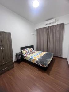 a bedroom with a bed and a dresser at Apartment in Sandakan @ Sri Indah Condominium in Sandakan