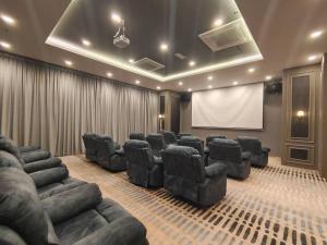 a conference room with leather chairs and a screen at Skytree A0902-(1) in Foodie City in Johor Bahru