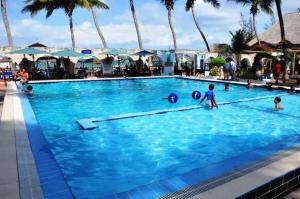 a pool with people playing with balls in it at Best Western Jangwani Sea Breeze Resort in Dar es Salaam