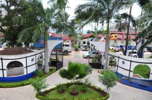 a parking lot with palm trees and a food truck at Best Western Jangwani Sea Breeze Resort in Dar es Salaam