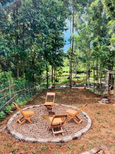 a group of chairs and tables in a circle at Aquawood Cabins in Kianyaga