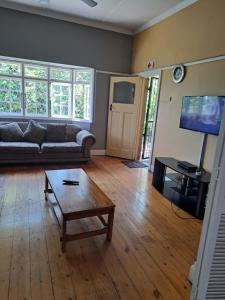 a living room with a couch and a coffee table at PMB Backpackers Lodge in Pietermaritzburg