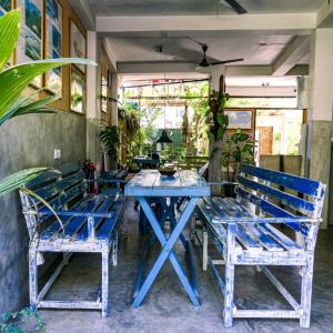 a blue table and chairs in a room at Cycling Backpacker Hostel in Unawatuna