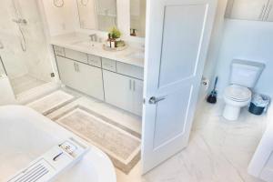 a bathroom with a toilet and a sink at Comfortable Modern Home in Downtown Houston - Sleeps 10 in Houston