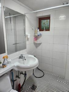 a white bathroom with a sink and a mirror at Hwarangdae Station One-room House in Seoul