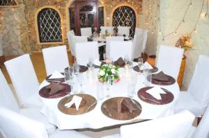 a table with white chairs and a table set with plates at Best Western Jangwani Sea Breeze Resort in Dar es Salaam