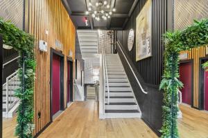 a hallway with stairs in a building with plants at Verdant Statuesque Intimate Acropolis Views Of Famous Park in Atlanta