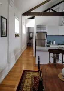 a kitchen and a living room with a table at Pips on Mitchell - Beautiful Historic Apartment in Bendigo +15 photos