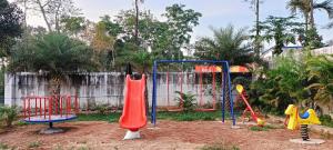 a playground with different types of play equipment at Coorg Le Embera in Virajpet