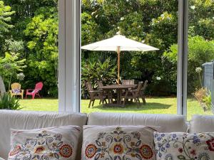 a living room with a couch and an umbrella at Mission Retreat in Kerikeri