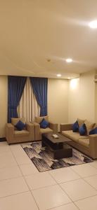 a living room with couches and a coffee table at ريف الخرج 2 للشقق الفندقية in Al Kharj