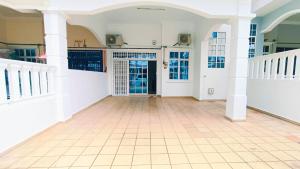 an empty hallway of a house with a tiled floor at 184 Kulai Homestay Tmn Gunung Pulai 3BR 9pax Shortstay in Kulai