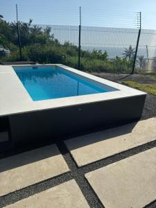 a rectangular swimming pool in a concrete slab at FlamencoAccommodation in Ballito
