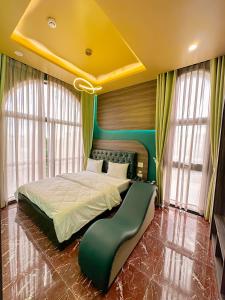 a bedroom with a large bed with a yellow ceiling at Tuyet Suong Hotel in Quang Ngai