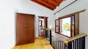 a hallway with a wooden door and a window at Templos Homes in Kyrenia