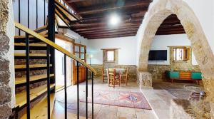 a room with a staircase and a living room with a table at Templos Homes in Kyrenia