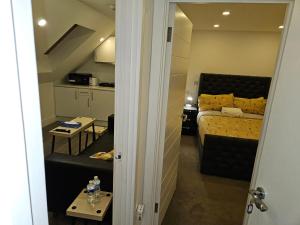 um pequeno quarto com uma cama e uma cozinha em London Glamour Apartment Two em Londres