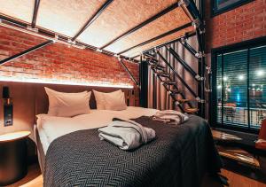 a dog laying on a bed in a room at Clarion Hotel Mestari in Helsinki