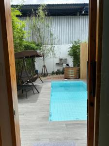 a swimming pool in the middle of a yard at RINA Poolvilla (รินะ พูลวิลล่า) in Hat Yai