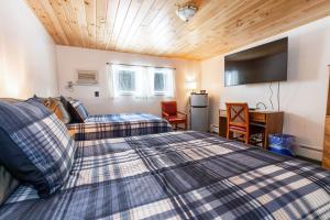 A bed or beds in a room at West Bethel Motel