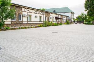 an empty parking lot in front of a building at Green Hall Hotel in Izmail