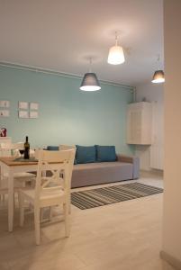 a living room with a table and a couch at BLUE APARTMENT 1 in Braşov