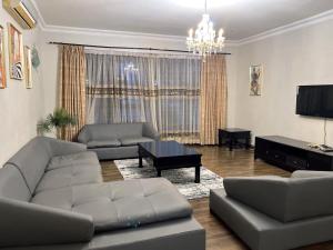 a living room with a couch and a table at Rose house in Dar es Salaam