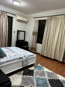 a bedroom with a bed and a rug at Rose house in Dar es Salaam