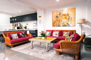 a living room with two couches and a table at 87 Guesthouse in Baguio