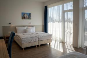 Postel nebo postele na pokoji v ubytování Aqua Hotel