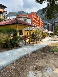 a street in a city with a yellow building at Adam Bungalows in Krabi town