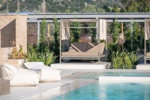 a living room with a swimming pool and a house at Oniro Boutique Hotel in Toroni