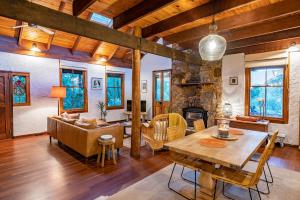 a living room with a table and a fireplace at The Enchanted Stone Cottage in Margaret River Town