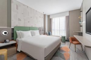 TV a/nebo společenská místnost v ubytování EVEN Hotel Zhongshan City Center by IHG