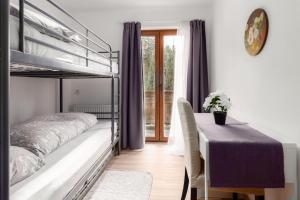 a bedroom with a bunk bed and a table with a tableablish at Gasthof Barlida in Lainach