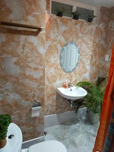 a bathroom with a sink and a mirror at Closest Studio with Balcony from Cebu Airport in Lapu Lapu City