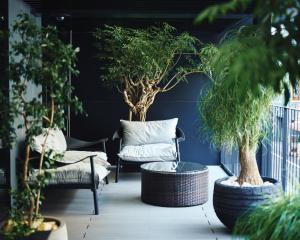 a patio with a chair and a table and plants at NOHGA HOTEL UENO TOKYO in Tokyo