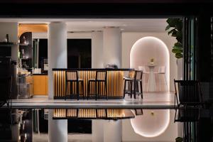 a dining room with chairs and a table in a house at The Bayou Hotel Langkawi in Pantai Cenang