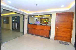 a man standing at a bar in a hotel lobby at HOTEL HANUWANT AIRPORT 7 Minutes Distance From IGI AIRPORT 3 Minutes From Aero City Metro Station Book Now For More Offers in New Delhi