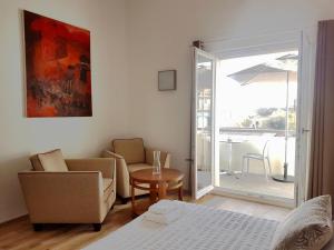 a living room with a couch and chairs and a table at B&B La Maison de la Côte in Biarritz